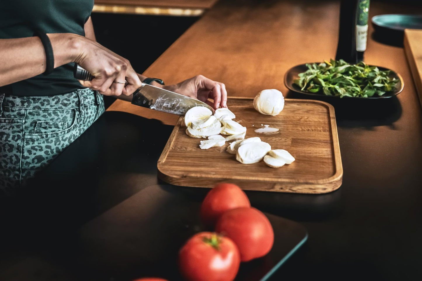 Tagliere Cut di Bravate Artigiane utilizzato per tagliare delle mozzarelle, nel tagliere estraibile sono stati appoggiate delle verdure che verranno tagliate in seguito.